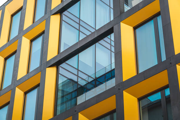istock interesting modern urban architecture. modern office building with glazed windows. interesting utility building. yellow building. 2193001688