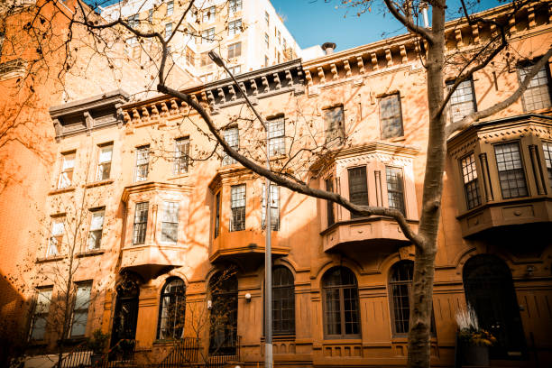 Row of New York brownstone townhouses with Christmas decorations on doors