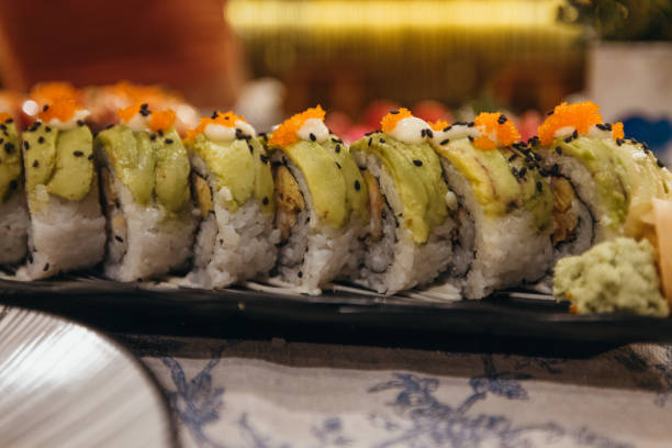 istock Close-up of Fresh Sushi Rolls with Avocado and Fish Roe 2193006407
