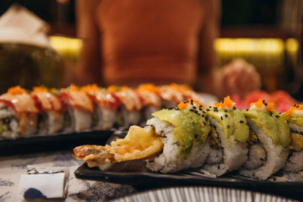 istock Close-up of Fresh Sushi Rolls with Avocado and Fish Roe 2193006463
