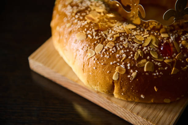istock Traditional sweet bread with sugar and almonds on a wooden serving board 2193006554