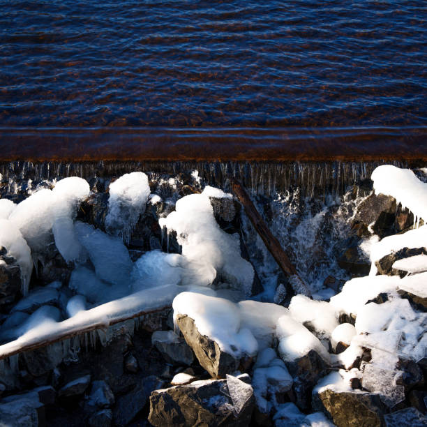 Snow covered and icy rocks along the shoreline of Lake Ontario.