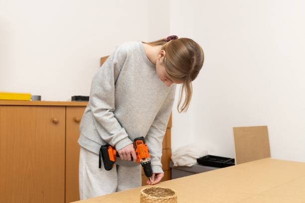 istock young girl uses an electric screwdriver 2193007818