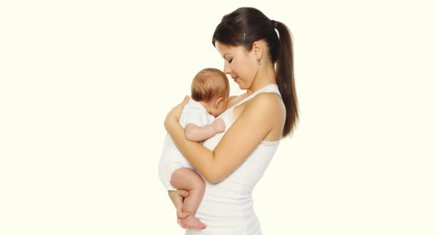 istock happy young mother holding baby on white studio background 2193008898
