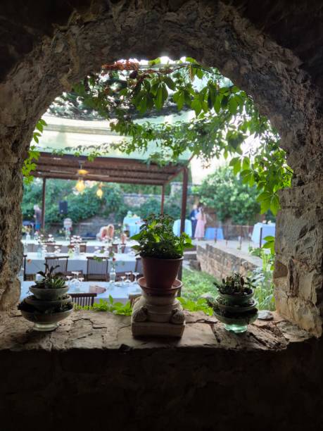 istock Arch with potted plants looking out into the garden. 2193010737