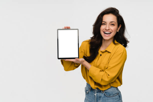 istock Young girl woman student holding digital tablet computer showing mock up screen display isolated 2193010749