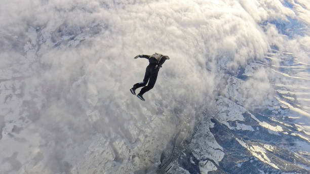 istock Freefall jumper flies above snowcapped mountains 2193014328