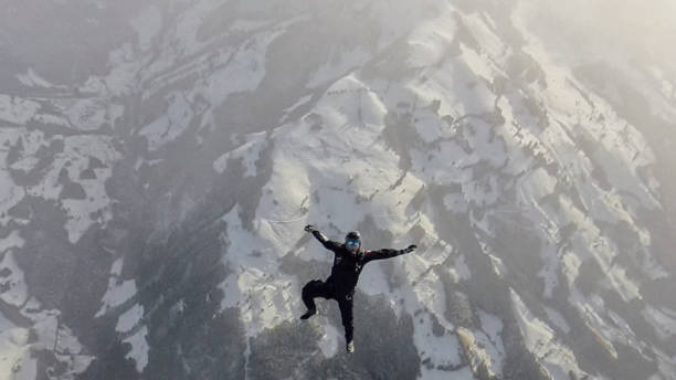 istock Freefall jumper flies above snowcapped mountains 2193014360