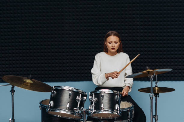 istock young woman playing drum set 2193016186