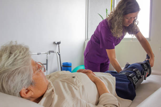 istock Nurse-helping-patient-to-lie-down-on-stretcher 2193019196