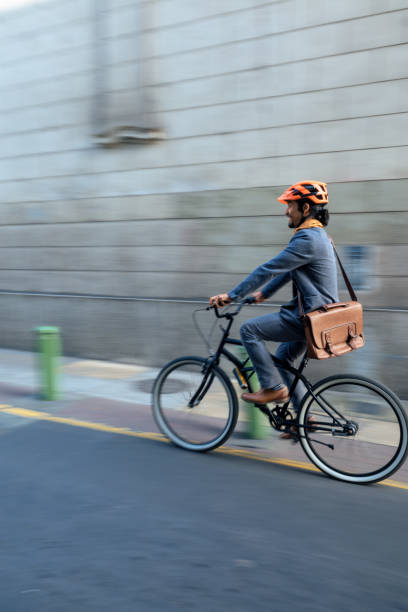 istock Man in motion on a bicycle, representing sustainable urban transport. 2193021331