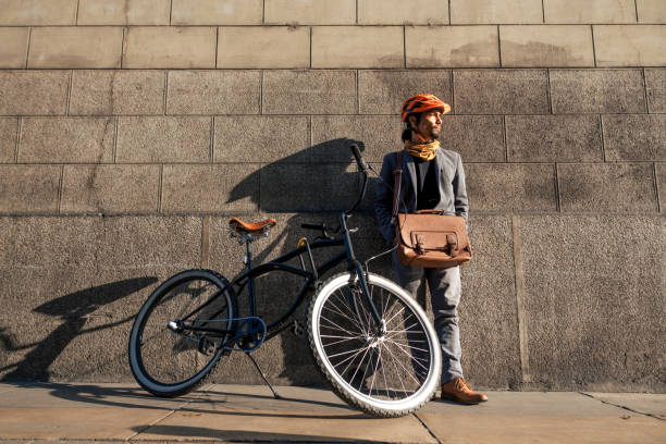 istock businessman with bicycle on the wall 2193021332