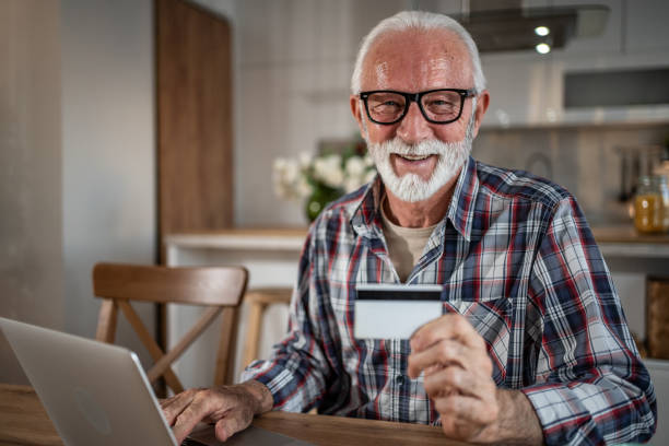 istock Smiling senior man using laptop at home. 2193022839
