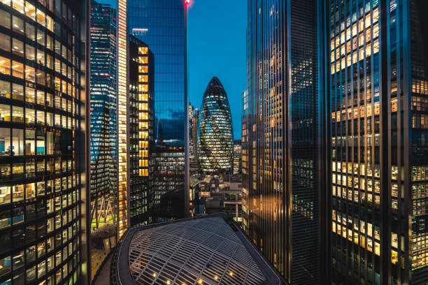 istock Illuminated office buildings in London at Night 2193027508