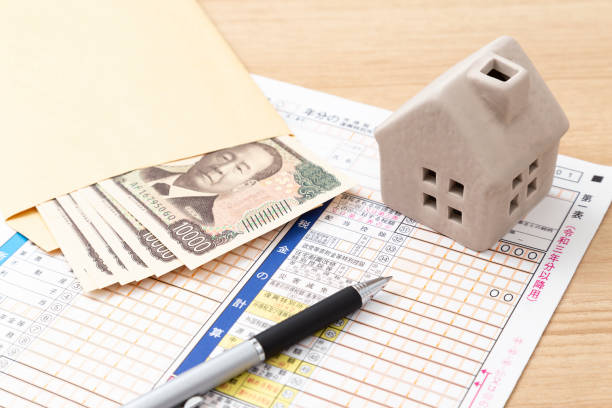 istock Tax return documents and a model house on a desk. 2193028934