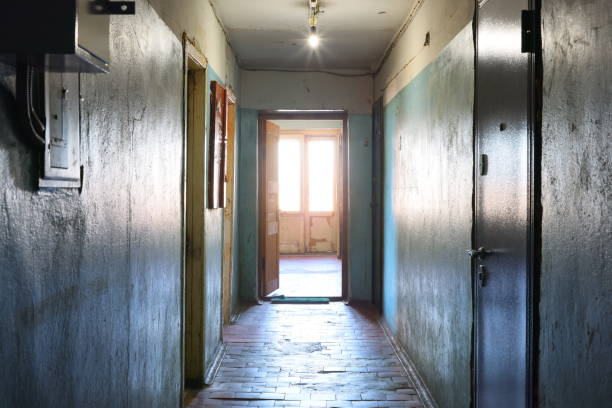 istock An Empty Corridor Featuring an Open Door and Bathed in Natural Light from Outside 2193032357