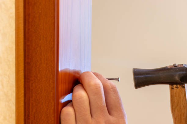 istock Hammering an iron nail into a wooden pillar 2193036039