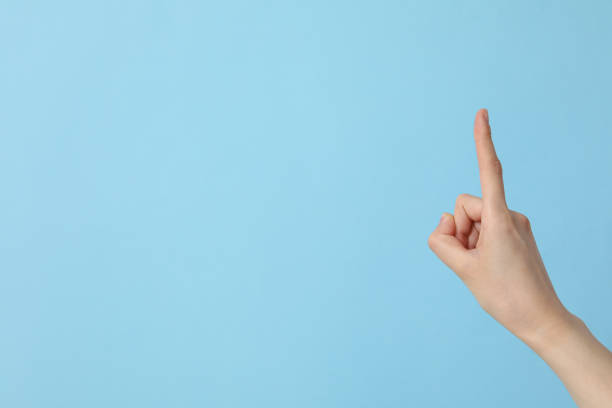 istock Female hand showing index finger on blue background, place for text 2193038763