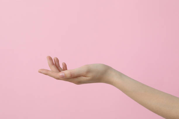istock Female hand on a beautiful pink background 2193038950