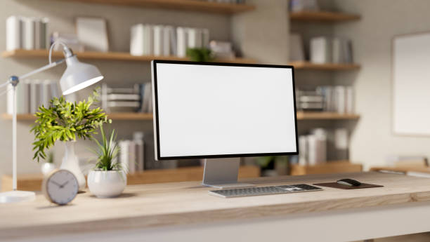 istock A computer with a white screen mockup and decor placed on a wooden desk in a room. 2193039009