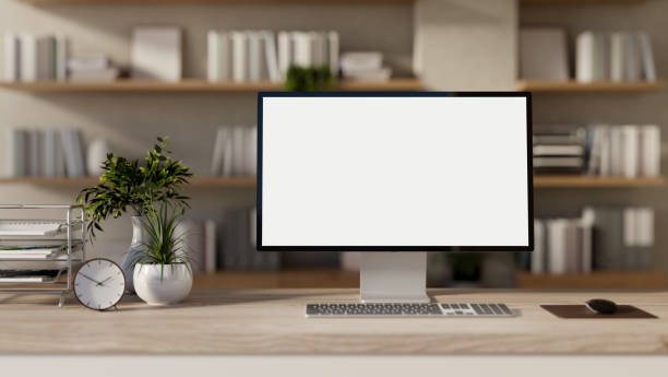 istock A computer with a white screen mockup and decor placed on a wooden desk in a room. 2193039019