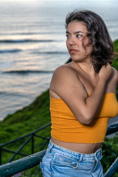 istock Young woman relaxing on malecon at sunset after work 2193040773