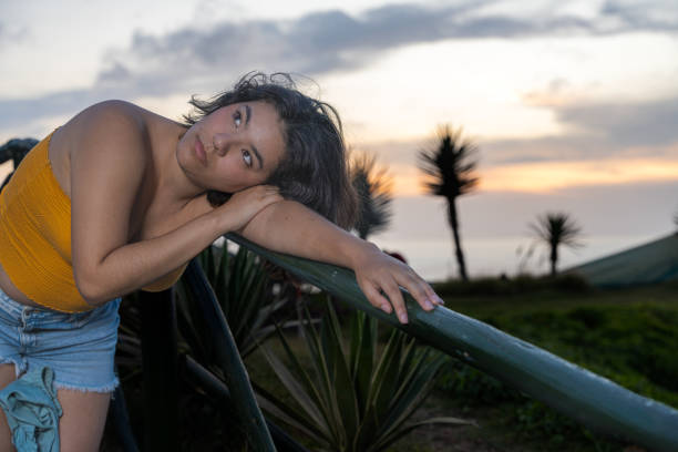 istock Young woman relaxing on malecon at sunset after work day 2193040802