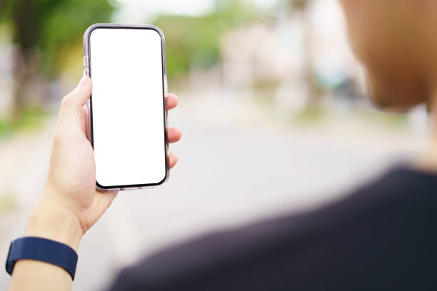 istock A man from rear angle is looking at the empty white screen smartphone while walking in the city street. 2193041454