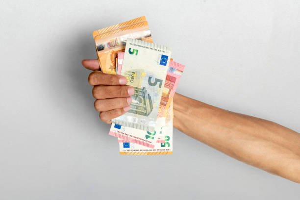 istock Human hand holding euro banknote cash on white background 2193043103