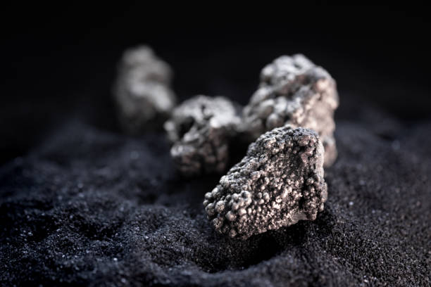istock Pure silver or platinum or rare earth from the mine that was placed on the black sand 2193045804