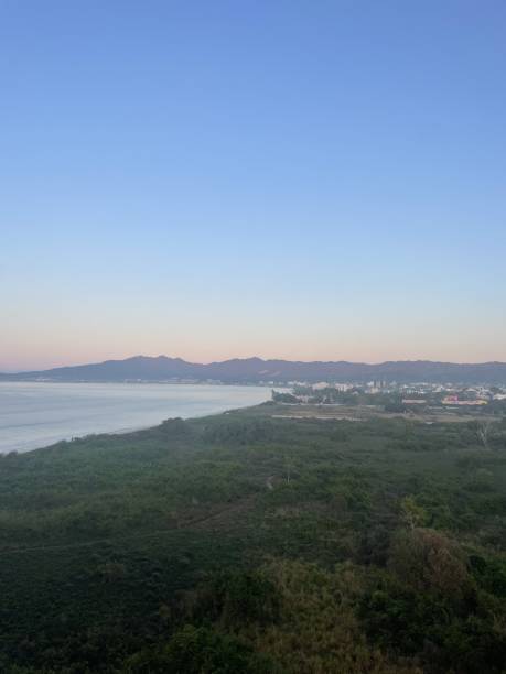 istock Morning Sunrise above trees and ocean with Mountains 2193048748