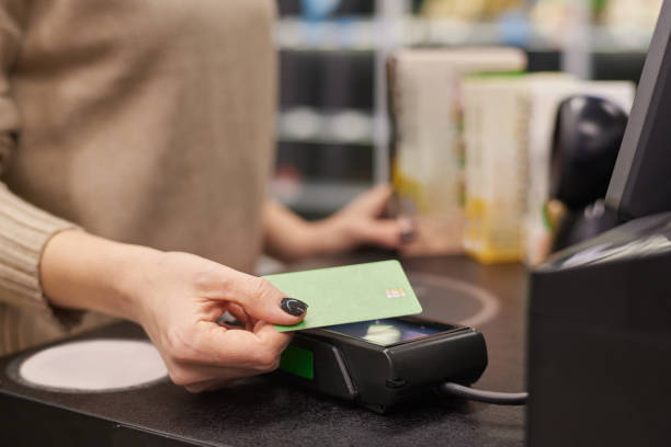 istock Woman paying in grocery store 2193049839