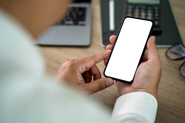 istock Close-up man hand mock up using phone blank screen background is blurred in office in communication 2193049907