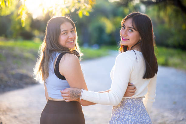 istock Two best friends hugging talking at sunset in the park 2193050661