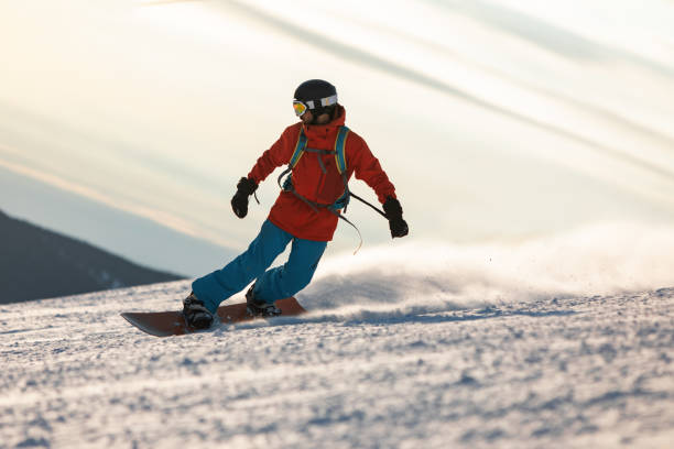 istock Mid adult men snowboarding in mountain 2193052295