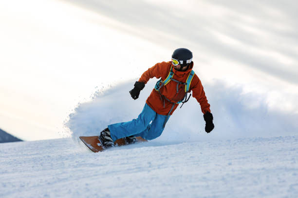 istock Mid adult men snowboarding in mountain 2193052413