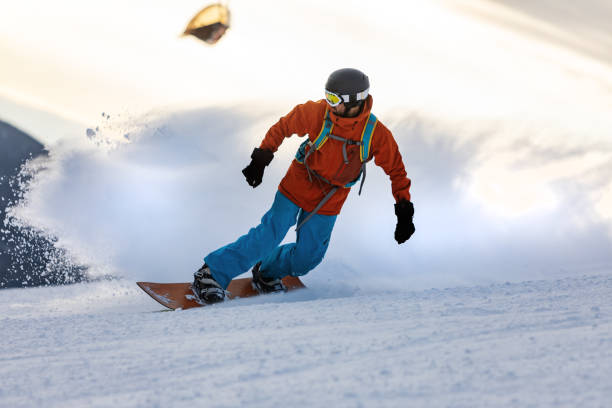 istock Mid adult men snowboarding in mountain 2193052938