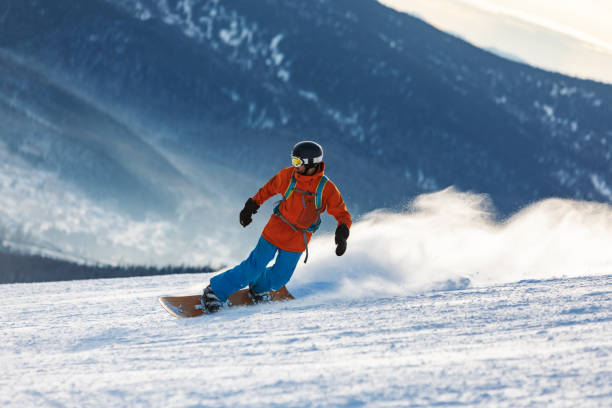 istock Mid adult men snowboarding in mountain 2193052963