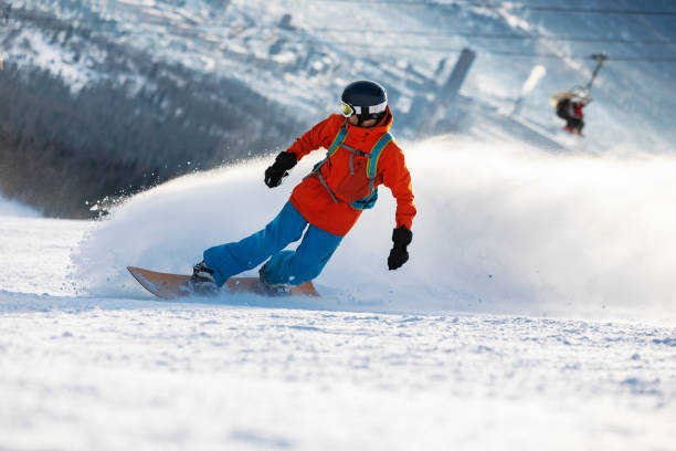 istock Mid adult men snowboarding in mountain 2193053143