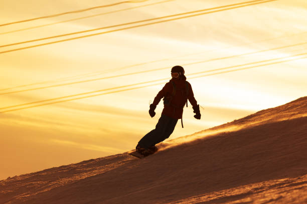 Mid adult men snowboarding in mountain