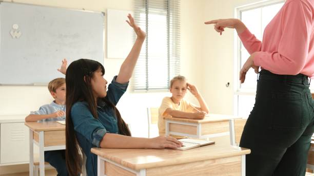 istock Happy asian student raising hand for volunteering at elementary class. Pedagogy. 2193054803