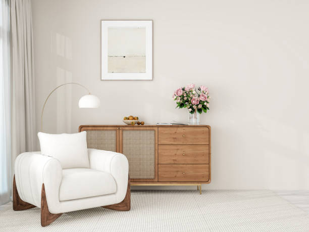 istock A minimalist interior scene featuring a blank wooden-framed picture frame on a light-colored wall, a black metal console table with a green plant, and a cozy beige armchair. 2193055736