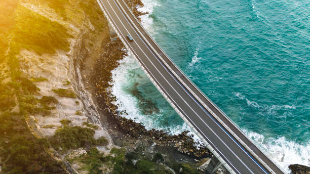 istock Fading golden sunlight adds color when looking down at a coastal highway bridge. 2193056751