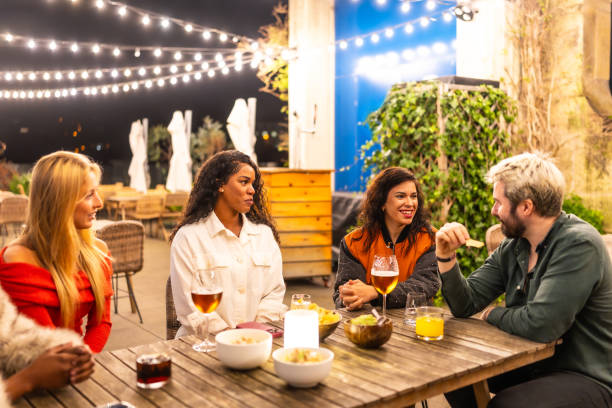 istock Friends talking relaxed in a night terrace bar 2193056852