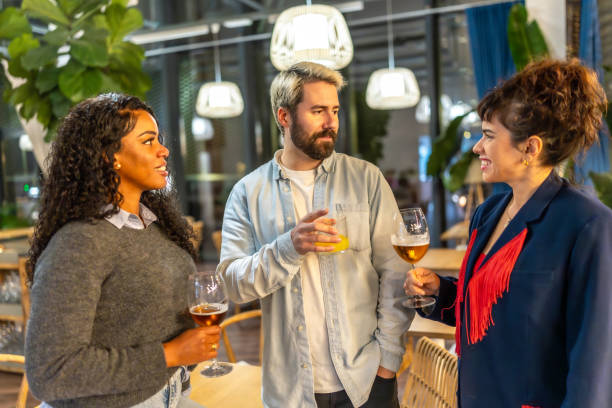 istock Diverse friends chatting and drinking in a night bar terrace 2193057058