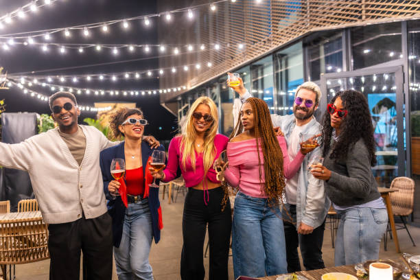 istock Multi-ethnic friends having fun at bar terrace at night 2193057088