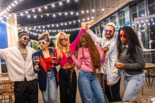istock Modern people celebrating party outside a bar at night 2193057089