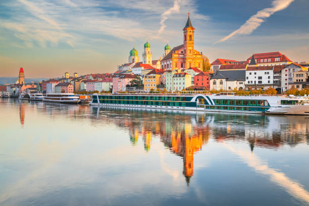 istock Passau, Germany. Waterfront sunset water reflection - old town cityscape with St. Stephan's Basilica and Danube River. 2193057730