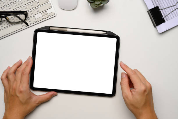 istock Hands holding a digital tablet with blank white screen at clean and minimalist workspace 2193058734
