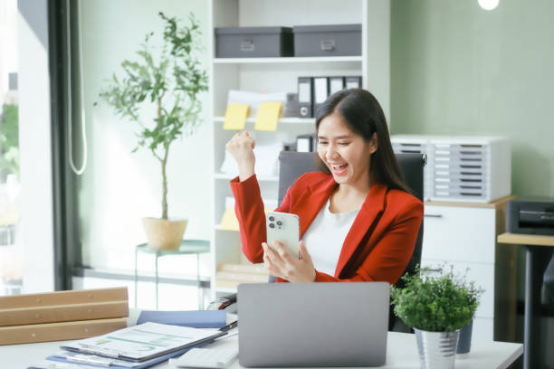 istock An Asian businesswoman works at her desk in a modern office, smiling while using a tablet to review financial analysis reports, manage accounting tasks, and oversee banking and loan documentation 2193058792
